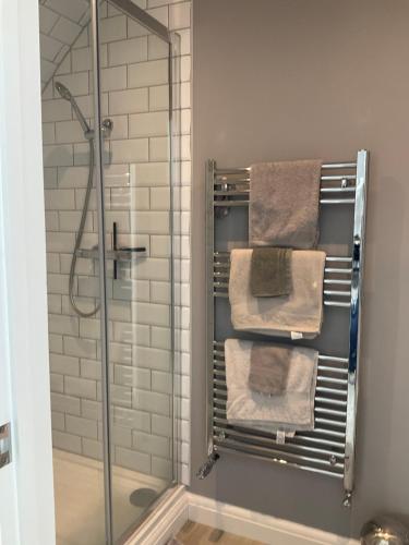 a towel rack with towels on it in a bathroom at Loft apartment in Herstmonceux