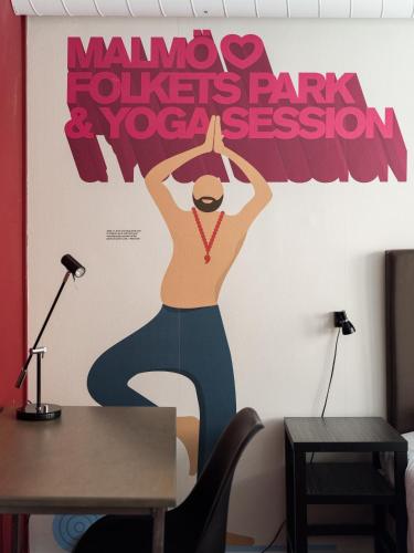 a wall mural of a woman with a medal at HOTEL N Hostel Malmö City in Malmö