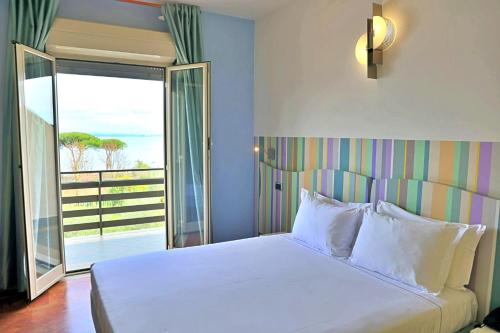 a bedroom with a bed with a view of the ocean at HA Hotel in Bracciano