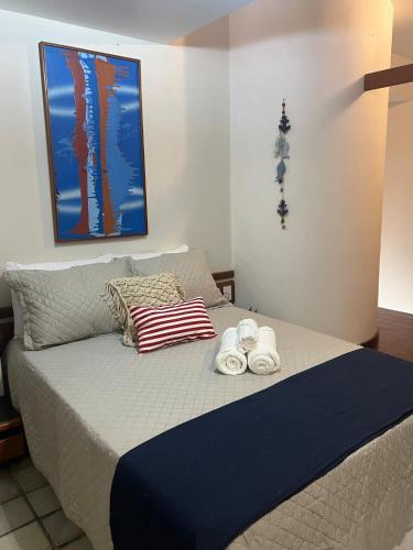 a bedroom with a bed with towels on it at Apt Areia e Maré in Maceió