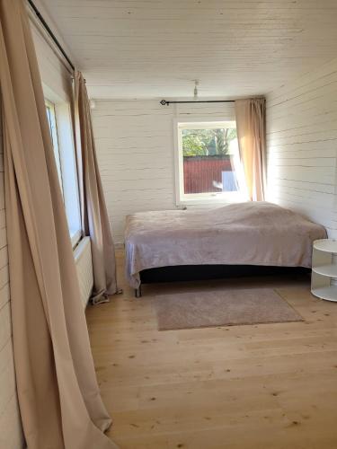 a bedroom with a bed and a window at Mörrum, Haus 2 & 3 in Mörrum