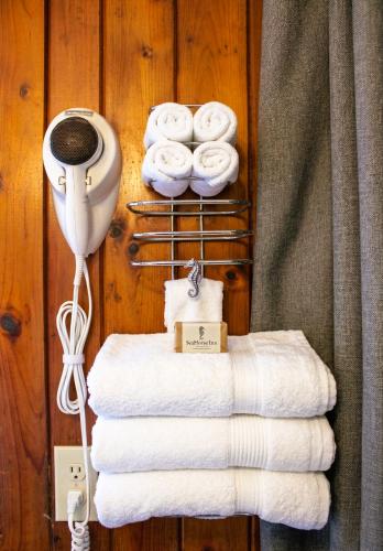 a bunch of towels on a rack with a stack of towels at Sea Horse Inn and Cottages in Nags Head