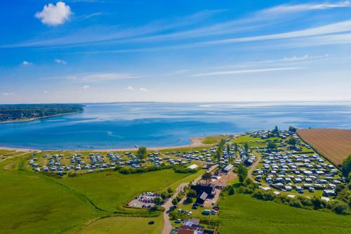 an aerial view of a parking lot next to the water at Vikær Strand Camping & Cottages in Diernæs