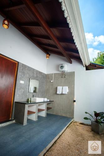 a bathroom with a sink and a mirror at Wimala Sewana in Veyangoda