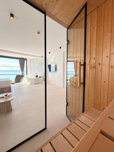 an open living room with a sliding glass door at Boutique Hotel Nika in Ohrid