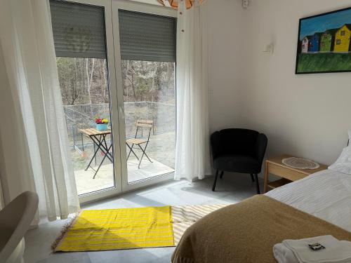 a bedroom with a bed and a view of a patio at Homestay in Dąbrowa Górnicza