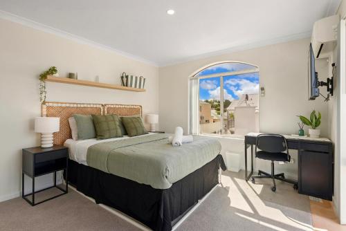 a bedroom with a bed and a desk and a window at Elysian Fields in Joondalup in Perth
