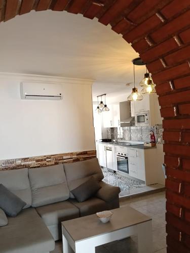 a living room with a couch and a kitchen at Apartamento en Torrox in Torrox