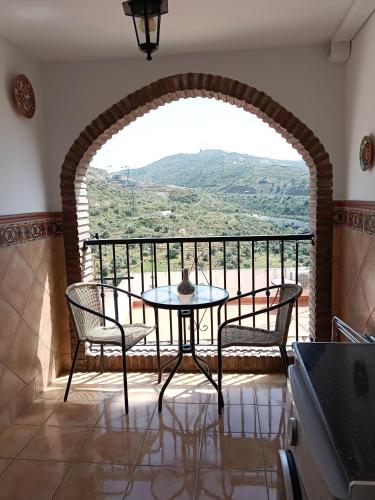 a table and chairs on a balcony with a view at Apartamento en Torrox in Torrox