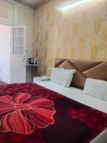 a bedroom with a large bed with a red blanket at HideOut The Mall in Shimla