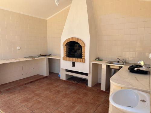 a kitchen with a pizza oven in a room at BnB Homes Luxurious Villa Stardust with Swimming pool & BBQ for Family Fun in Ameijoafas