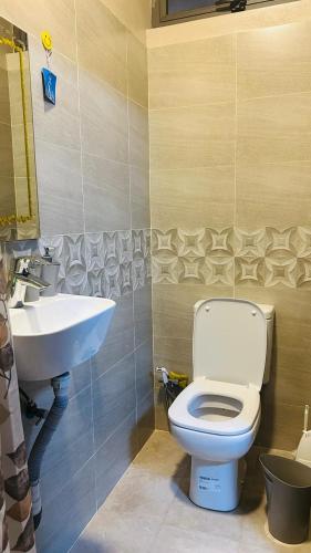 a bathroom with a toilet and a sink at cozy home in Argy