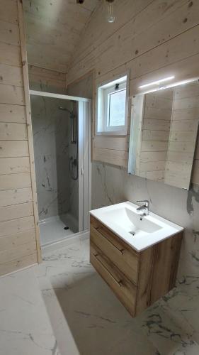 a bathroom with a white sink and a shower at Camping Luni in Marina di Massa