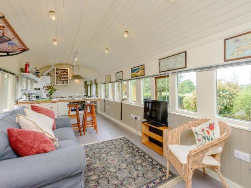 a living room with a couch and a tv at Sprat & Winkle in Horsebridge