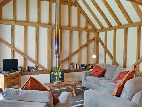 a living room with two couches and a table at The Old Packhouse in Steyning