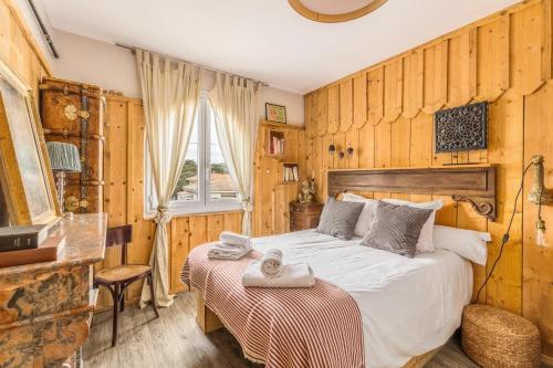 a bedroom with a large bed and a window at Hôtel Le Caillebotis in Cap-Ferret