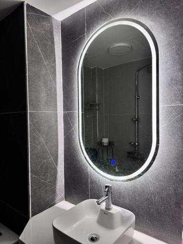 a bathroom with a sink and a mirror at Maison du nook in Hanoi