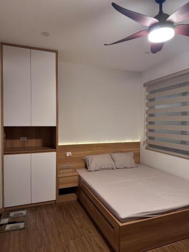 a bedroom with a bed and a ceiling fan at Maison du nook in Hanoi