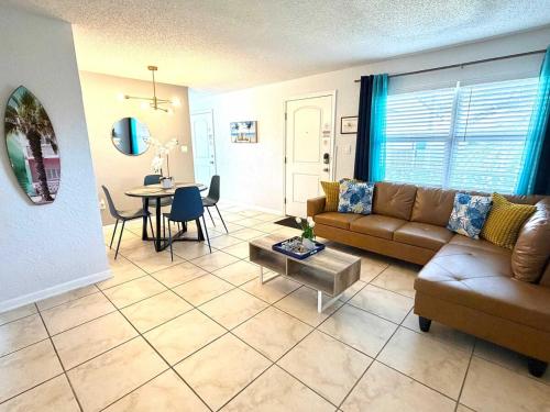 a living room with a couch and a table at Ocean 32 - Swimside in Indian Harbour Beach