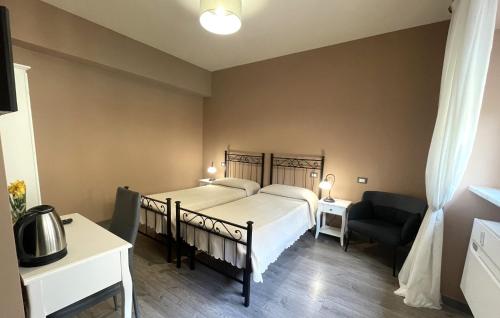 a bedroom with a bed and a desk and a chair at Madame Pucci in Lucca