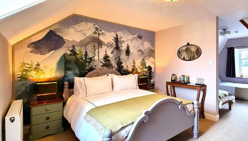 a bedroom with a bed with a painting on the wall at Craigbuie Guesthouse in Killin