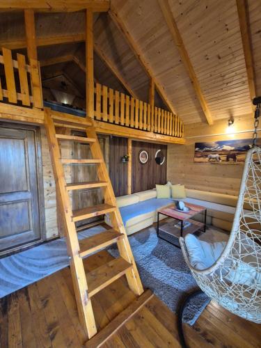 a room with a loft bed and a hammock in a cabin at Cabin House Dubovik in Cetinje