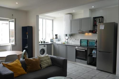 a living room with a couch and a kitchen at Sea Breeze Apartment in Lagos