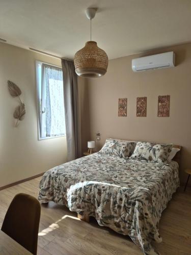 a bedroom with a bed with a comforter and a window at Hibiscus Affittacamere - rooms&more in Stanghella