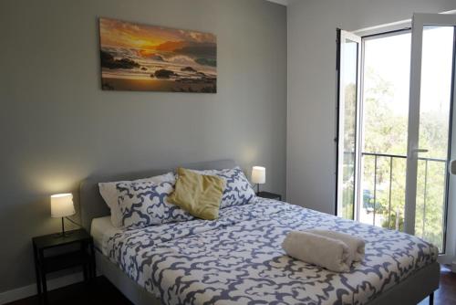 a bedroom with a bed and a window at Sea Breeze Apartment in Lagos