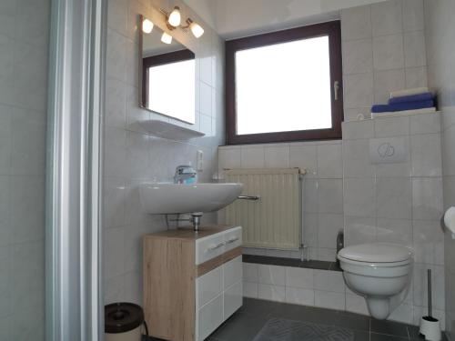 a bathroom with a sink and a toilet at Haus Gertrud in Carolinensiel