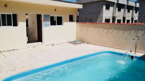a swimming pool on the side of a building at Condomínio - Dell Mar III in Bertioga