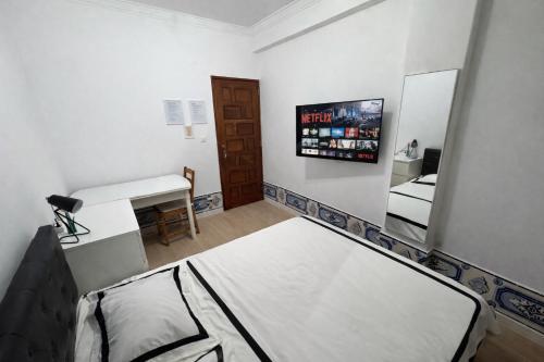 a small room with a bed and a mirror at Double Room near Sintra & Lisbon in Queluz