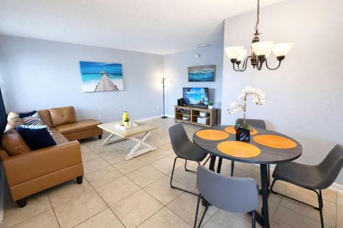 a living room with a table and a couch at Ocean 16 - Pier View in Indian Harbour Beach