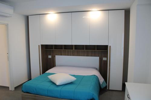 a bedroom with a bed with a blue pillow at Perla dell'Adriatico in San Benedetto del Tronto