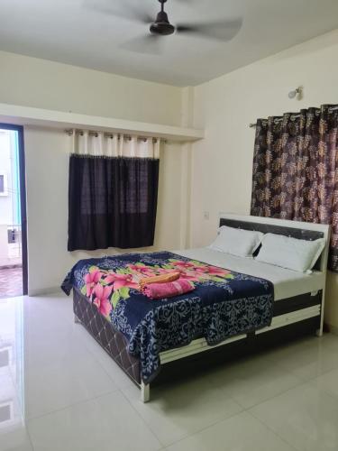 a bedroom with a large bed with a colorful blanket at Umashankar Homestay in Nashik