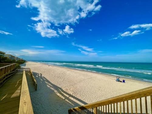 a view of a sandy beach with the ocean at Ocean 19 - Tideside in Indian Harbour Beach