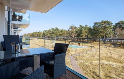 a balcony with a table and chairs and a view of a field at Prince in Binz