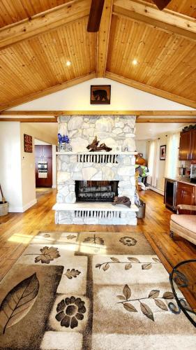 a living room with a stone fireplace in a house at The Fireside Lakehouse in Bridgeport