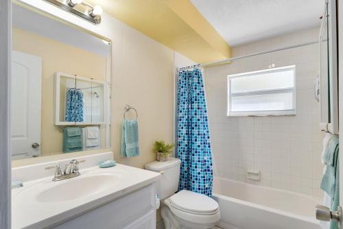 a bathroom with a sink and a toilet and a tub at Ocean 6 - Surfside in Indian Harbour Beach