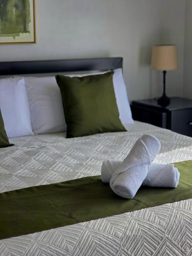 a bed with a pair of towels on it at Casa del Lago #3 in Upala