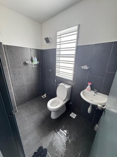a bathroom with a toilet and a sink at KY Stay D'Serkam in Serkam