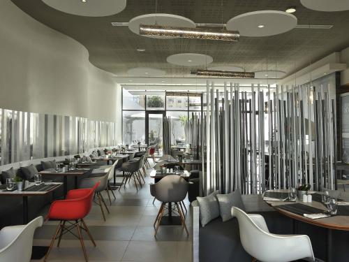 a restaurant with a long line of tables and chairs at Ibis Casa Voyageurs in Casablanca