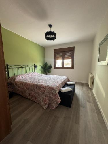 a bedroom with a bed and a window at Casa Herrero Valderrobres in Valderrobres