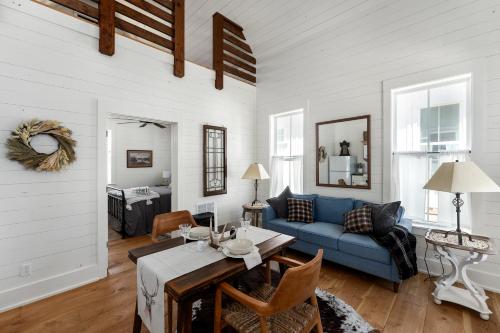 a living room with a blue couch and a table at Cedar Break at Howard Ranch in Driftwood