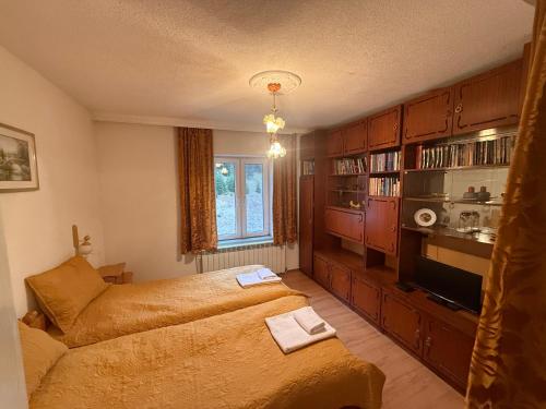 a bedroom with a bed and a couch at Къща Ники in Stoykite