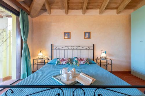 a bedroom with a bed with a blue comforter at Villa Belvedere Saline - Private Pool in Stintino