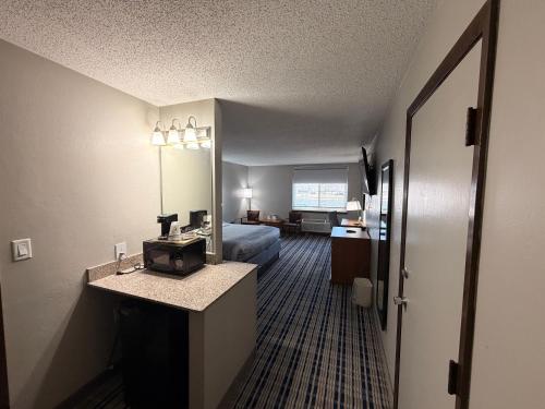 a hotel room with a bed and a mirror at Americinn by Wyndham Appleton Downtown in Appleton