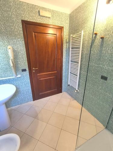 a bathroom with a shower and a glass door at Residenza Borgo Francescano in Gioia del Colle