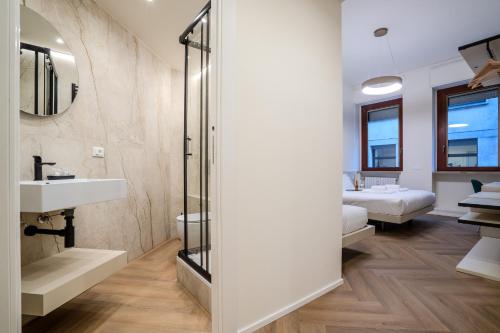 a bathroom with a shower and a sink and a mirror at Italianflat - Duomo Atmosphere Two in Milan