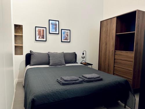 a bedroom with a bed with three towels on it at Casa Politi in Parma